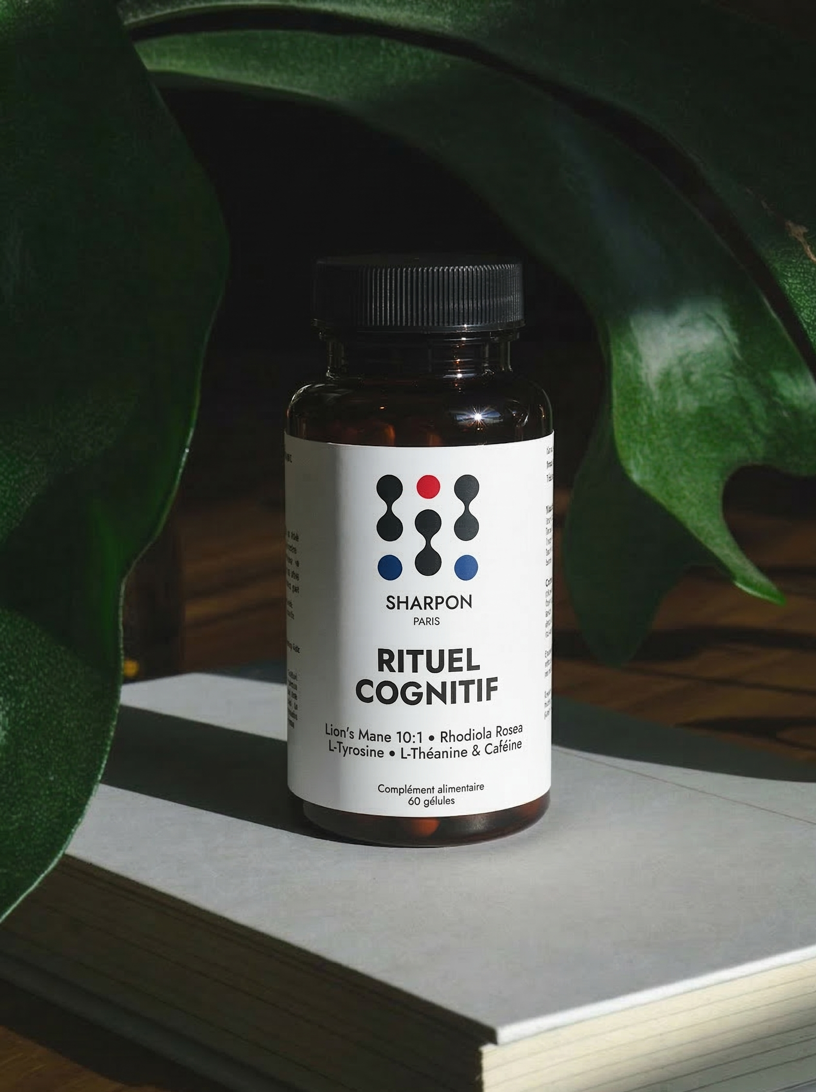 Bottle of Sharpon rituel cognitif (nootropic) on a surface with green leaves in the background